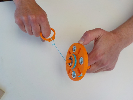 Hand spinner with string launcher